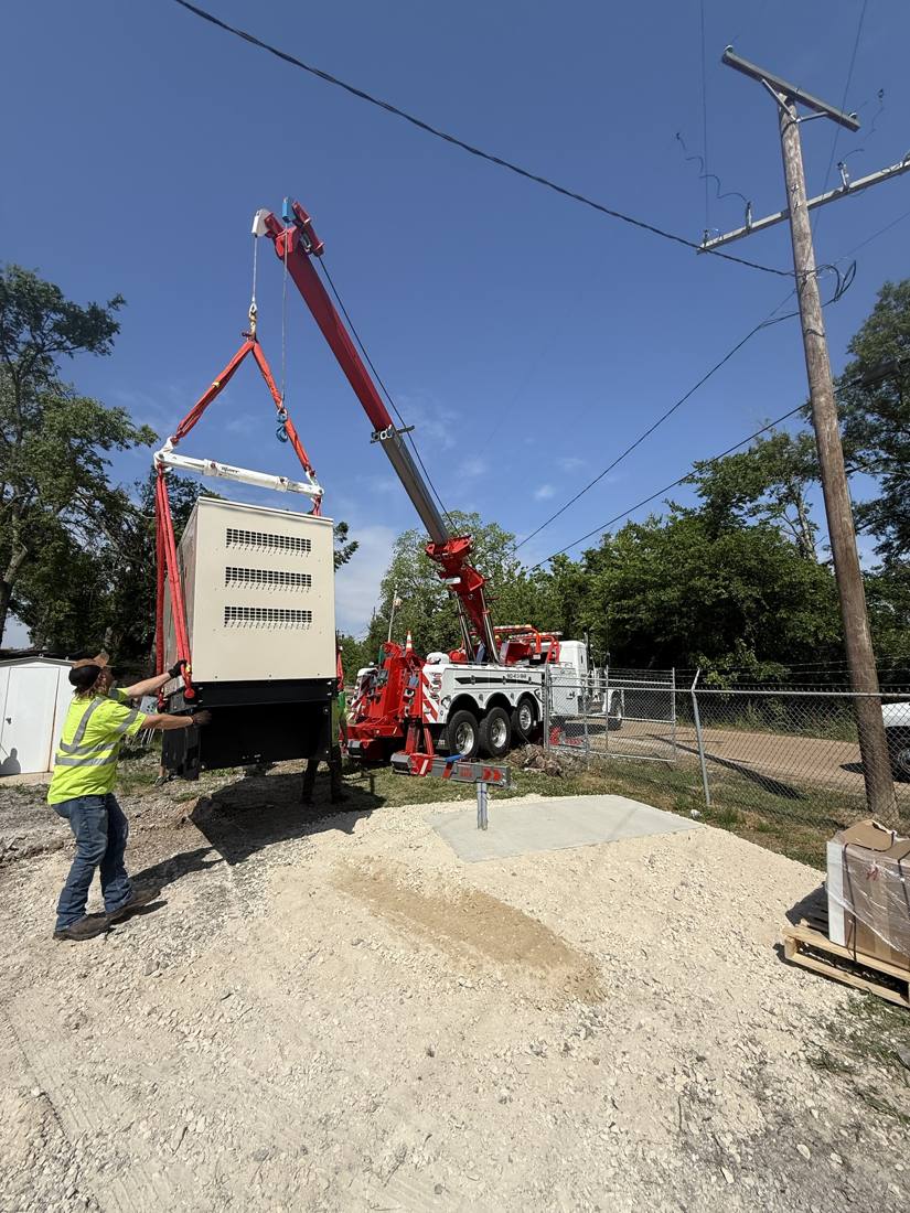 Setting a generator with a rotator wrecker. Power lines kept a conventional crane from working in the area.