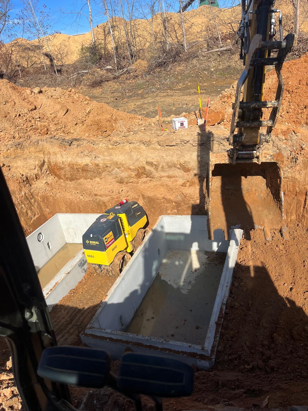 Two 5,000 gallon tanks set in the excavation
